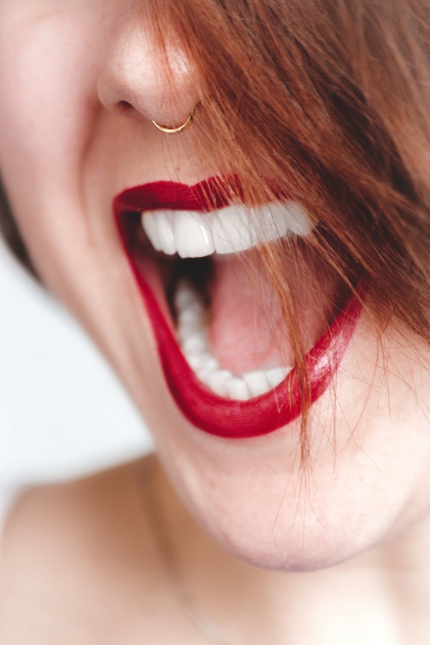 woman in red lipstick opening her mouth